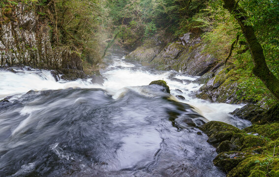 long exposure of white water cascading over the magnificent Rhaeadr Ewynnol Swallow Falls Waterfall, Betws-y-coed, Snowdonia National Park, Wales UK