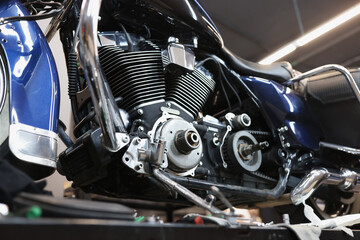 Fototapeta na wymiar Motorcycle engine on stand in car workshop closeup