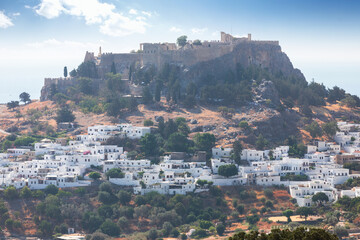 Panoramic view of the old town of Lindos in Greece with the acropolis on top of the hill.