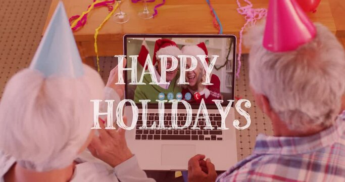 Animation of happy holidays text over senior couple making christmas video call with family