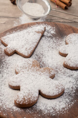 Traditional christmas gingerbread cookies over a wooden table with sugar