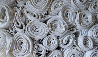 White fabric rolls close up.