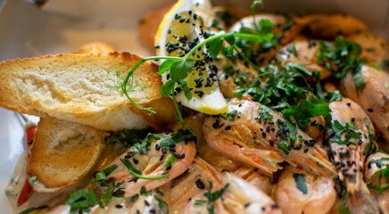 oysters in cream sauce.decorated with black caviar and greens