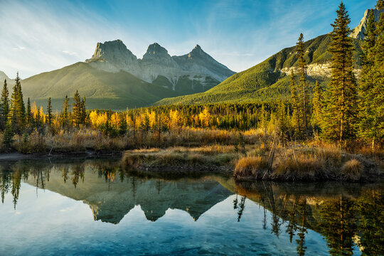 Sunrise over the Three Sisters that is reflecting in Policeman Creek