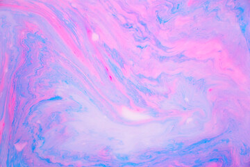 Abstract colored marble background, stains of pink and blue paint on the surface of the water. Liquid colorful backdrop.