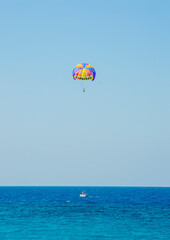 Fototapeta na wymiar Two person enjoying the Parasailing at Akti Kanari Beach Greece