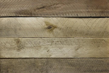 Wall from dark and light wooden planks. Wonderful wooden texture. Pattern of saw tooth marks.