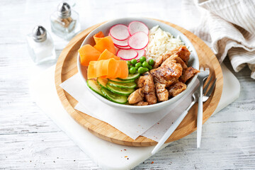 Healthy Vegan Poke bowl salad, heura vegetable protein, vegan chicken with variety vegetables, rice, served in bowl, light background. Copy space, selective focus. Lunch, vegetarian restaurant menu. - obrazy, fototapety, plakaty