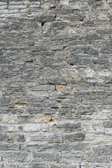 Old brick wall of different size sandstone bricks as a natural background