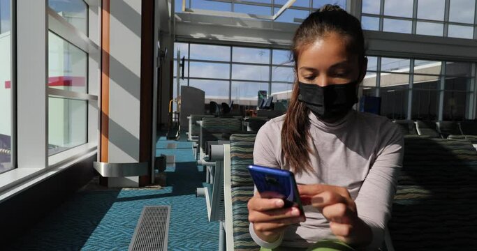 Mandatory face wear to cover mouth with mask protection. Asian woman using mobile phone app waiting flight departure in airport terminal banner. Travel tourist businesswoman during coronavirus