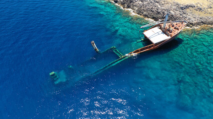 Aerial drone photo of famous shipwreck of "Nordland" half sunk ship in islet of Prasonisi near Diakofti main port of Kithira island, Ionian, Greece