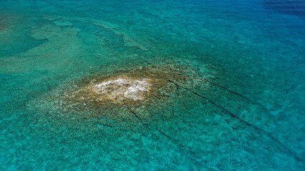 Aerial drone photo of tropical exotic paradise bay with deep turquoise sea and caves forming a blue lagoon visited by luxury yachts and sail boats