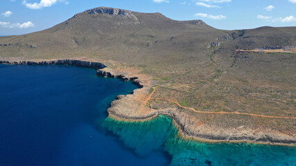 Aerial drone photo of tropical exotic paradise bay with deep turquoise sea and caves forming a blue lagoon visited by luxury yachts and sail boats