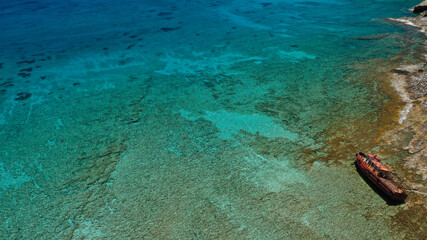 Aerial drone photo of tropical exotic paradise bay with deep turquoise sea and caves forming a blue lagoon visited by luxury yachts and sail boats