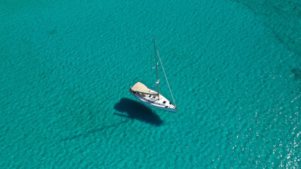 Fototapeta premium Aerial drone photo of luxury sail boat anchored in tropical exotic paradise bay with turquoise sea