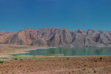 Africa Morocco desert Atlas mountains nature rock landscape with river palm under blue sky hot weather 
