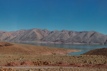Africa Morocco desert Atlas mountains nature rock landscape with river palm under blue sky hot weather 