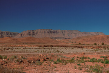 Africa Morocco desert Atlas mountains nature rock landscape with river palm under blue sky hot weather 