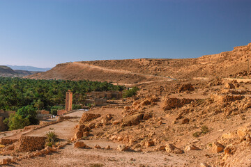 Africa Morocco desert Atlas mountains nature rock landscape with river palm under blue sky hot weather 