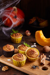 Halloween treats. Muffins with pumpkin, walnuts and cinnamon. Delicious homemade dessert.