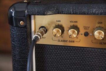 Guitar amplifier closeup, cable connected - obrazy, fototapety, plakaty