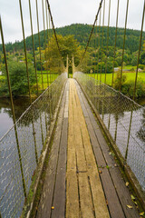 Obraz premium Sappers Suspension Bridge, Betws-y-Coed, an iron bridge built over the river Conwy in the 1930's by David Rowell and Co Ltd. to replace the 1917 army combat engineers (Sappers) wooden bridge. 