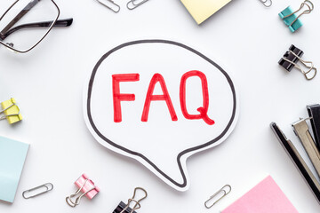 Word faq frequently asked questions with stationery on working place