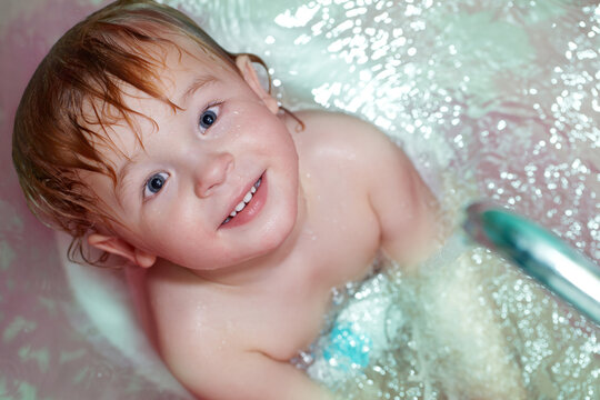 Little boy takes a bath.