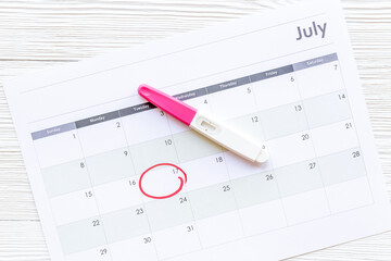 Pregnancy test with calendar to check pregnancy day