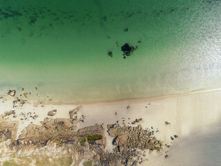 Aerial view on Gurteen bay and beach, county Galway, Ireland. Top down view. Sand, rocks and ocean surface