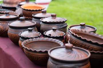 Earthenware at market. Jugs, plates, jugs, bottles from clay