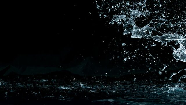 Super slow motion of big water splash on black background. Filmed on high speed cinema camera, 1000 fps.