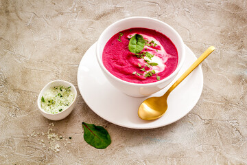 Cream soup made of red beet roots with basil