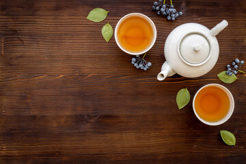 Asian food and drink set white teapot and black tea in two cups