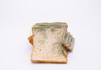 Mouldy bread isolated on white background.
