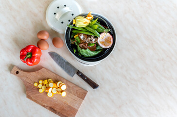 Food waste inside the metal compost bin. Zero waste concept.