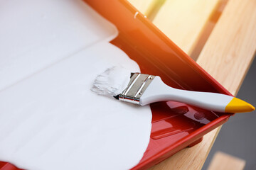 Painted tool with paint brush and paint roller on paint tray for painting