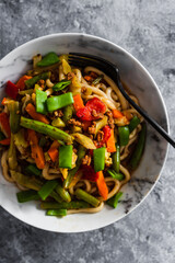 vegan mixed vegetables stir fry with udon noodles, healthy plant-based food