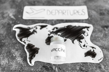 international travel after the covid-19 pandemic, world map with vaccine and departures sign