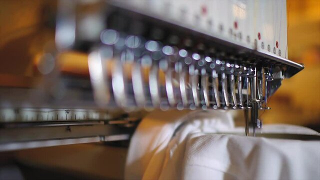 Commercial embroidery machine embroidering logo on a T shirt