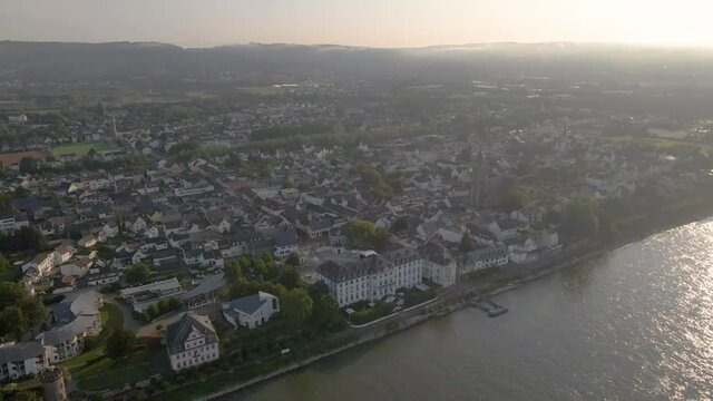 Drone Panning Directly Above Engers Town And Castle On Rhine River, Koblenz On A Sunny Afternoon