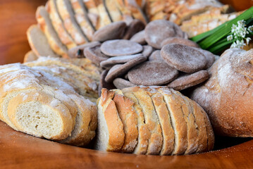 assortment of baked bread, bread basket, sliced ​​breads, baker's day, breakfast table