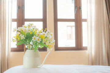 Platic white flower decoration in house with sunny day background.