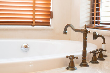 Copper tap of hot and cold water beide bathtub.