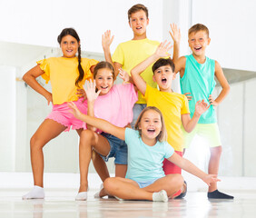 Happy emotional children posing at modern dance class
