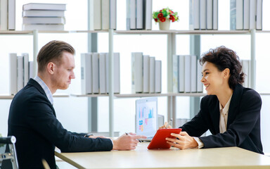 Executive caucasian manager laugh and smile as enjoy business talking together with happy colleauge woman during relax for discussion and consult about joyful teamwork at corporate office