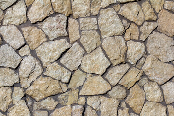 The texture of a stone wall. A stone wall as a background or texture.