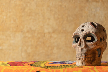 Prehispanic skull made of clay and decorated with Aztec motifs