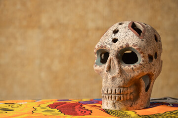 Prehispanic skull made of clay and decorated with Aztec motifs