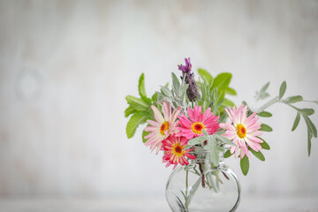 Collection of fresh flowers picked from cottage garden in small vase